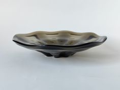 a black and white bowl sitting on top of a table