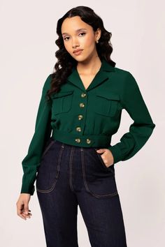 Looking for a trendy addition to your fall wardrobe? The Ravenwood Jacket has got you covered. This vintage-inspired cropped jacket comes in khaki, dark green, and dark red, and features a flattering v-neckline, pointed collar, and slightly puffed sleeves with button detailing. With 2 chest pockets and large buttons, this jacket is both stylish and functional. Made from 97% Polyester and 3% Elastane, it has a slight stretch for a comfortable fit. Pair it with denim jeans or tapered trousers for Tapered Trousers, Border Print, Large Buttons, Wiggle Dress, Puffed Sleeves, Cropped Jacket, Workout Jacket, Red Jacket, Fall Wardrobe