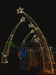 an ice cream cart is decorated with christmas lights and stars in the shape of snowflakes