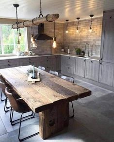 a large wooden table sitting in the middle of a kitchen