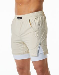 HIGHLIGHTS. Woven, compression-lined short. 5.5” Inseam. Front slip pockets. Size Up, if you don’t like compressive fit. Runs small, consider sizing up. Upgraded smoother and softer Infinity fabric. Waterproof zipper on the right side with YKK zippers. Laser cut perforations for breathability. Custom branded flat profile drawstrings. Alphalete Infinity logo in premium silicone. Alphalete Athletic logo printed on left thigh FIT SUGGESTION. This item runs true to Alphalete’s standard sizing.. If y White Nylon Yoga Shorts, Sporty Beige Athletic Shorts, Beige Sporty Athletic Shorts, Sporty Beige Activewear With Built-in Shorts, Beige Short Sporty Activewear, Beige Compression Athleisure Activewear, White Compressive Breathable Shorts, Beige Activewear With Built-in Shorts, Beige Activewear Shorts For Workout