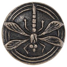 a metal button with a dragonfly on it's back and two wings in the middle