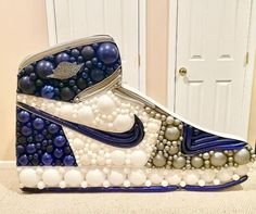 a nike shoe made out of balls and beads is shown in front of a door