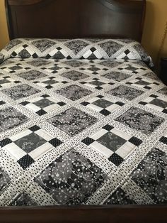 a black and white quilt on a bed