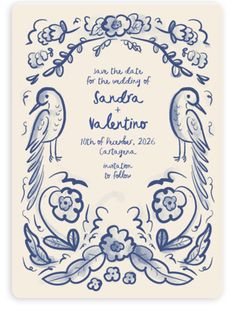 a blue and white wedding card with two birds on the front, surrounded by flowers