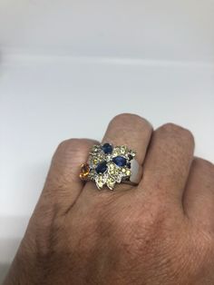 Unusual Deep Toned Sapphire and citrine Sterling Filigree Setting Handmade Size 5 Can be resized, my jeweler charges $10-$20 All rings are shipped in a nice gift box. Check out our over a THOUSAND great reviews!!! Engraving is $4 per letter and is not always perfect depending on the piece. It can take a few days if the jeweler is busy. This is payable to Paypal Judithsltd@gmail.com Multicolor Sapphire Ring For Gift, Sapphire Gemstones Gift, Elegant Yellow Sapphire Ring As Gift, Elegant Yellow Sapphire Gift Ring, Elegant Yellow Sapphire Ring For Gift, Multi-stone Topaz Promise Ring, Multicolor Sapphire Gemstones For Gifts, Yellow Hallmarked Sapphire Ring Gift, Sapphire Multi-stone Jewelry Gift