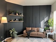 a living room filled with furniture and plants