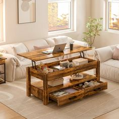 a living room filled with furniture and a laptop computer on top of a wooden table