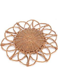 a round wicker placemat with an intricate design on the center and sides, set against a white background