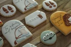 decorated cookies are arranged on a wooden table