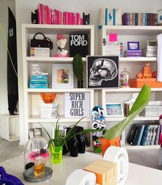 a living room filled with lots of books and furniture