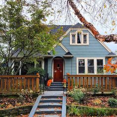 a blue house with stairs leading to the front door