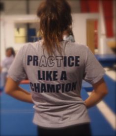 the back of a woman's shirt that says practice like a champion