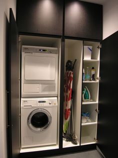 a washer and dryer are in the closet