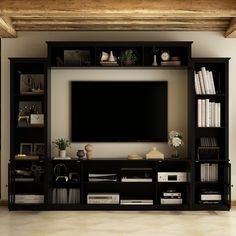 an entertainment center with bookshelves and a flat screen tv mounted on the wall