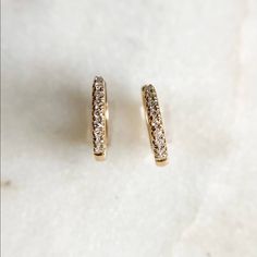 These beautiful 14K Yellow Gold Diamond Mini Hoop Earrings are a subtle and elegant way to add some sparkle to any look. The 8.5mm diamond hoop earrings feature SI clarity, J color diamonds and are guaranteed to be 100% pure gold. Add a subtle sparkle to your style with these beautiful earrings. 𝑫𝑴𝑲 𝑱𝒆𝒘𝒆𝒍𝒓𝒚 Huggie Diamond Earrings With Vs Clarity, Wedding Hoop Huggie Earrings With Single-cut Diamonds, Vs Clarity Diamond Huggie Earrings, Formal Huggie Diamond Earrings With Halo, Diamond Halo Huggie Earrings, Formal Halo Huggie Diamond Earrings, Small Hoop Diamond Huggie Earrings For Anniversary, Classic Diamond Huggie Earrings With Halo, Minimalist Diamond Huggie Earrings With Accents