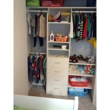 an organized closet with clothes and other items