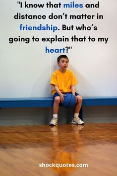 a young boy sitting on top of a basketball ball next to a wall with a quote