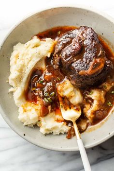 a bowl filled with meat and mashed potatoes