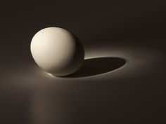 an egg is casting a shadow on the floor with it's back end up