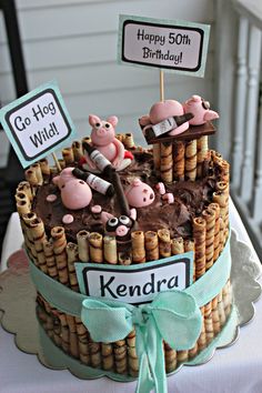 a birthday cake decorated with pigs and bamboo sticks