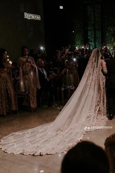 a bride and groom walking down the aisle at their wedding ceremony in front of an audience