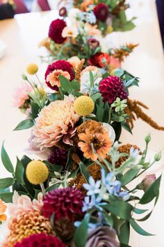 a row of flowers sitting on top of a table