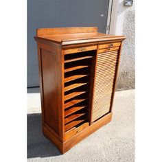 an old wooden cabinet with shutters open