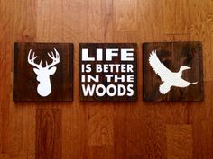 three wooden signs on the wall that say life is better in the woods and deer