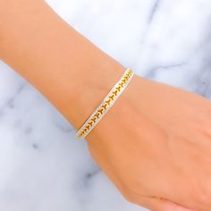 This bangle combines the allure of 22k gold with an opulent design, featuring an elegant interplay of yellow and white gold finishes. It has a light yet substantial feel with a weight of 15.6 grams, signifying high-quality craftsmanship. Tailored with a size of 2.6 and an opening of 2.35 inches, it provides a comfortable and versatile fit for a range of wrist sizes. This piece is crafted for those who appreciate the luxurious charm of gold and seek a sophisticated accessory that melds classic and contemporary styles. Its refined appearance makes it an excellent choice for enhancing any outfit, adding a touch of charm and opulence. PRODUCT DETAILS Gold Purity(karat): 22k Gold Weight(grams): 15.6 Item Finish: Yellow + White Gold Size: 2.6 Bangle Opening: ﻿2.35" Number Of Pieces: 1 Bangle Sty Yellow Gold Jubilee Bangle Bracelet, Hand Set Gold Plated Diamond Bracelet, Hand Set Gold-plated Diamond Bracelet, Hand Set Yellow Gold-plated Bracelet, Gold Plated Diamond Bangle Bracelet, Hand Set Yellow Gold Plated Bracelet, Gold Hand-set Chain Bracelet For Anniversary, Elegant Yellow Gold Plated Bangle, White Gold-plated Bangle Bracelet