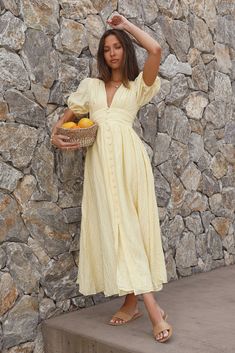 Get all booked up this holiday with museum tours and cooking classes in your dream destination. The Busy Bee Maxi Dress in Yellow is perfect for all sorts of activities. Pair with white heels for class or sandals for comfort. Maxi dress. true to size Short puffed sleeves V neckline Button detail from bust to hem Invisible zipper on back Lined 80% Viscon 20% Nylon Non-stretch Please refer to the care label on your garment for specific instructions on how to care for it Model wears XS Length from Flame Pants, Pale Yellow Dress, Yellow Chiffon Dress, Yellow Boho Dress, Pale Yellow Dresses, Yellow Summer Dress, Yellow Clothes, Picnic Dress, Purple Midi Dress