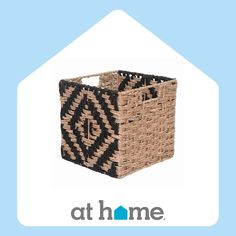 a woven basket with black and white designs on the bottom, sitting in front of a blue background