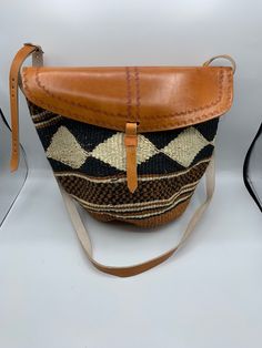 Sisal Kenyan bags that are lined inside and are adjustable. They come in many beautiful colors and designs. Woven Leather Bags In Natural Color, Artisan Handwoven Bucket Bag, Leather Bucket Straw Bag For Market, Artisan Natural Shoulder Bag For Travel, Travel Pouch Straw Bag With Woven Leather, Handwoven Leather Bucket Bag In Natural Color, Natural Weaved Straw Bag For Travel, Traditional Straw Tote Bag For Everyday Use, Artisan Woven Tote Bags