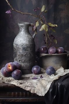 a still life with plums and a vase on a table cloth next to it