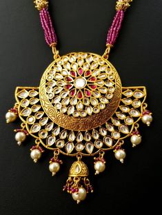 Look beautiful and feel beautiful wearing this gorgeous Indian kundan and pearl pendant necklace in chandbali design. Bright yellow gold colored crescent moon surrounds a stunning pattern of tear drop shaped kundan, which catches the light so nicely! The necklace is outstanding - lush and full multi strand necklace of sparkly faceted red crystals alternating with glowing, delicate tiny pearls. Matching jhumka earrings with pearls and red crystal accents, and clear and red stones. Effect is stunn Indian Bridal Jewelry, Thread Necklace, Red Stones, Polki Necklace, Necklace Indian, Indian Necklace, Bollywood Jewelry, Beaded Belt, Bridal Jewellery Indian