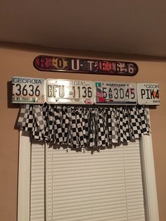 the license plates are hanging on the window sill in front of the windowsill