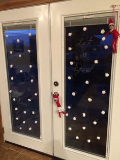 an elf's door is decorated with snowballs