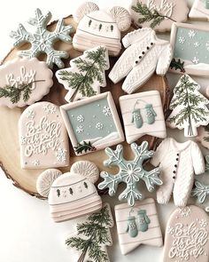 decorated cookies are arranged on a wooden platter