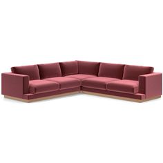 a pink sectional sofa sitting on top of a white floor