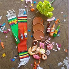 an assortment of toys and accessories laid out on the floor with confetti scattered around them