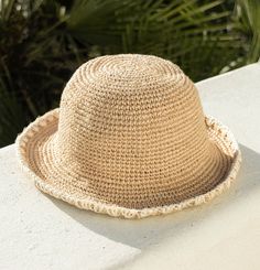 a straw hat sitting on top of a white table