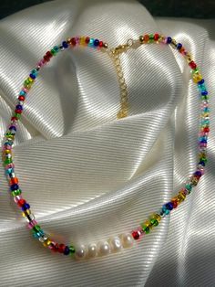 super cute rainbow beaded necklace with freshwater pearls to match your summer outfits  made with stainless steel gold  water resistant but still recommend to take good care of it to make your jewelry last longer  no refunds thank you Trendy Gold Pearl Beaded Necklaces, Summer Gold Pearl Necklace, Trendy Pearl Beaded Choker Necklace, Trendy Rainbow Necklaces With Tiny Beads, Trendy Beaded Choker With Pearl Chain, Trendy Beaded Pearl Chain Choker Necklace, Trendy Gold Beaded Pearl Necklace, Trendy Beaded Necklaces With Pearl Chain For Gifts, Trendy Pearl Jewelry With Tiny Beads