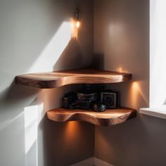 the corner shelf is made from wood and has two lights on each side, along with other items