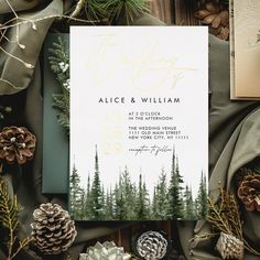 wedding stationery with pine cones and evergreen trees