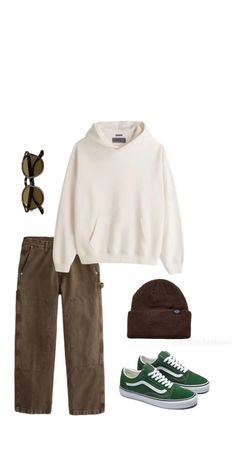 a white sweater, brown pants and green sneakers are outfitted for the winter months