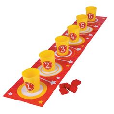 a red table runner with yellow cups and plates on it that have the number thirteen on them