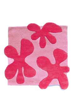 a pink rug with three red flowers on the top and one flower in the middle