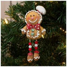 a gingerbread ornament hanging from a christmas tree