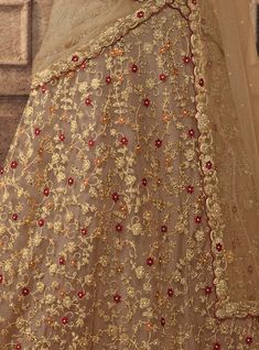 Dark Beige Designer Heavy Embroidered Net Wedding Lehenga-Saira's Boutique Floral Embroidered Sharara With Traditional Drape For Wedding, Floral Embroidery Sharara With Traditional Drape For Wedding, Wedding Sharara With Floral Embroidery And Traditional Drape, Floral Embroidery Sharara For Diwali Wedding, Wedding Sharara With Floral Embroidery For Diwali, Gold Semi-stitched Set With Floral Embroidery, Wedding Gold Sharara With Floral Embroidery, Gold Semi-stitched Anarkali Set With Floral Embroidery, Fitted Gold Sharara With Floral Embroidery