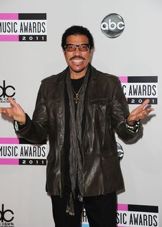 the singer poses on the red carpet at the 2011 american music awards